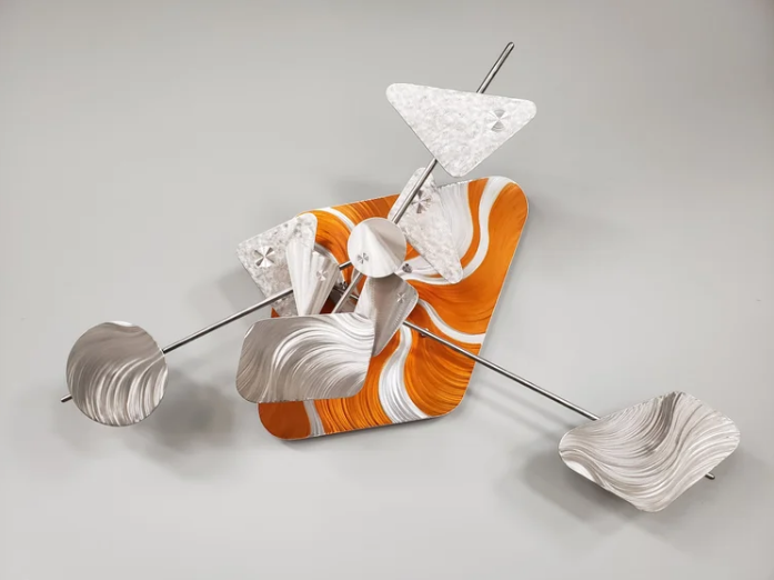 Kinetic sculpture with orange enamel panel and brushed-steel kinetic arms