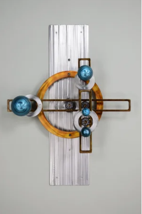 Kinetic wall sculpture with teal discs and copper rings